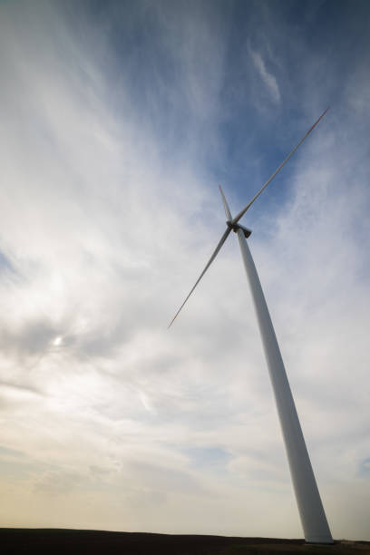 istock One wind turbine with cloudy sky in background 1156770596