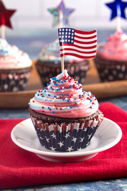 istock American Themed Cupcakes with Flags on a Blue Wooden Table 1156770688