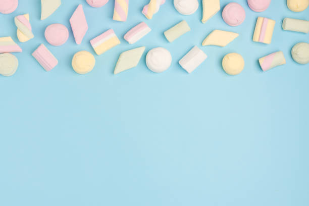 istock Blue paper background with marshmallow. Cozy sweet background 1156771048