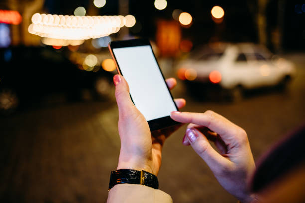istock Close-up of blank mobile phone screen in woman's hands 1156772500