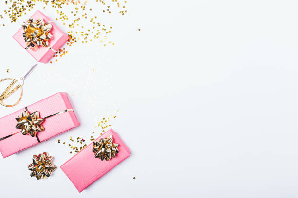 istock Festive pink gift boxes with golden bows 1156772501