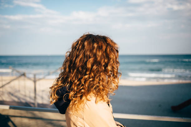 istock Female head with red curly hair 1156772555
