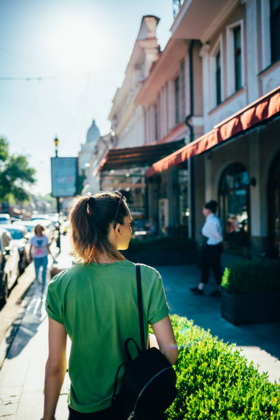 istock Back view young woman tourist 1156772595