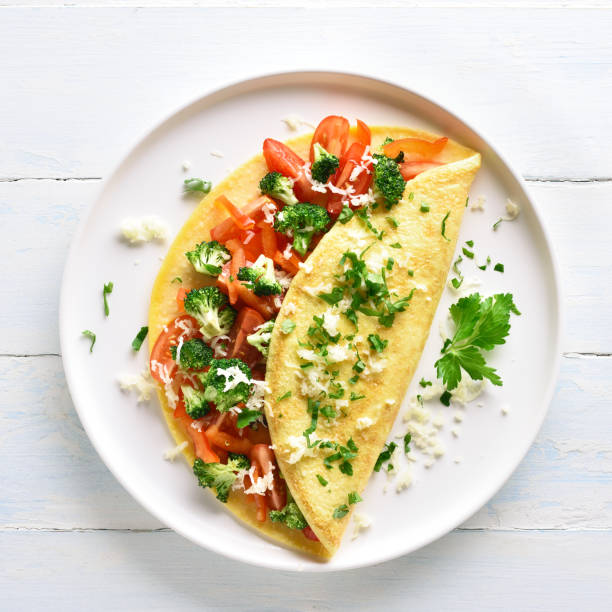 istock Stuffed omelette with tomatoes, red bell pepper and broccoli 1156773115