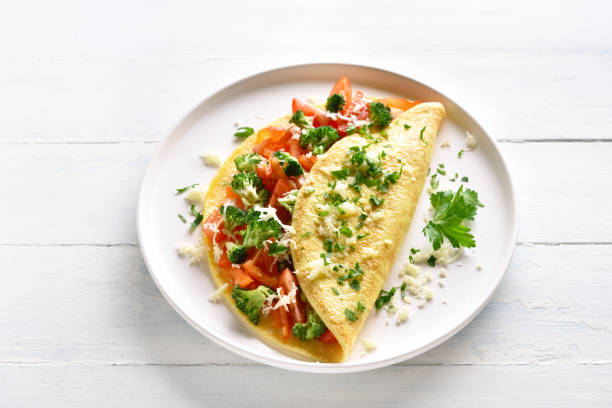 istock Stuffed omelette with tomatoes, red bell pepper and broccoli 1156773118