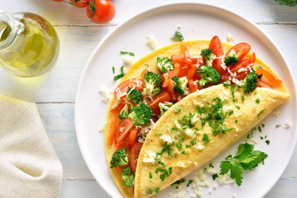istock Stuffed omelette with tomatoes, red bell pepper and broccoli 1156773129