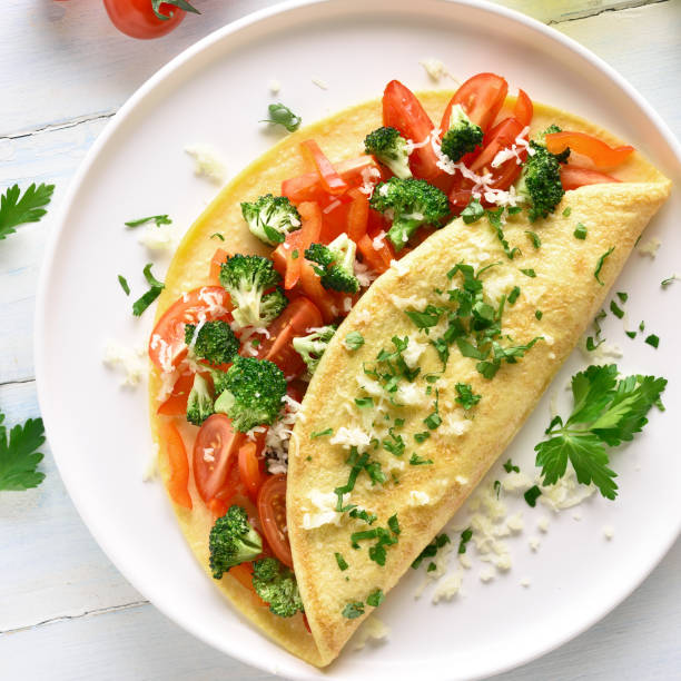 istock Stuffed omelette with tomatoes, red bell pepper and broccoli 1156773146