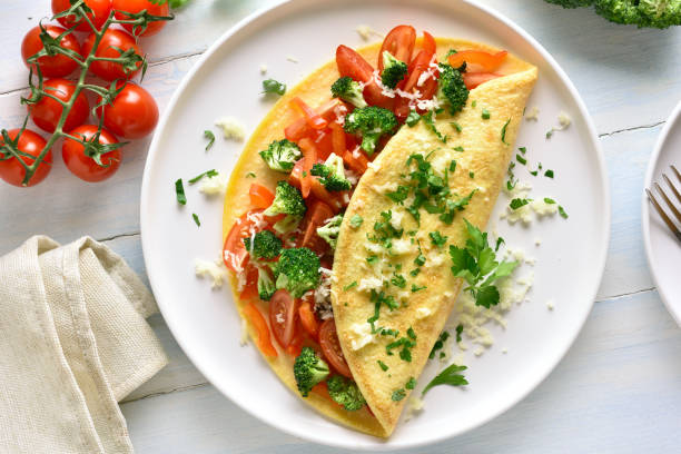 istock Stuffed omelette with tomatoes, red bell pepper and broccoli 1156773147