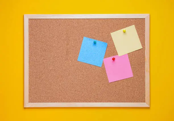 multicolored corkboard stickers pinned with buttons. yellow background.