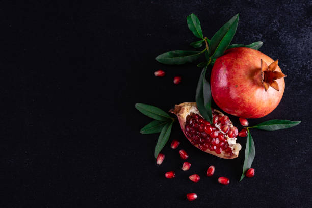 istock Red juice pomegranate on dark background 1156777702