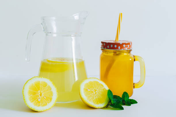 Lemonade jar and pitcher on a white background