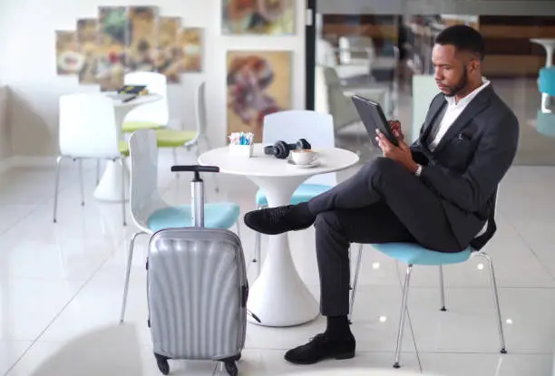 Photo of African business man checking in to a hotel.