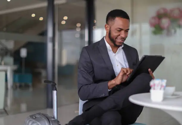 Photo of African business man checking in to a hotel.