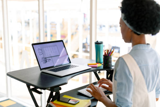 istock Female graphic designer working on laptop at desk 1156780594