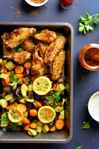 istock Grilled vegetables and chicken wings 1156780727