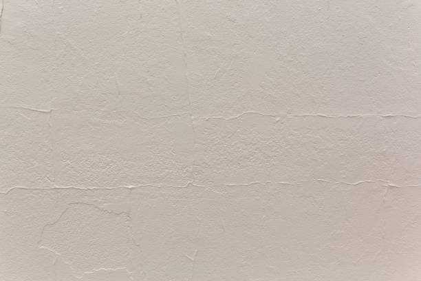 istock Concrete block wall covered with stucco and painted 1156785120