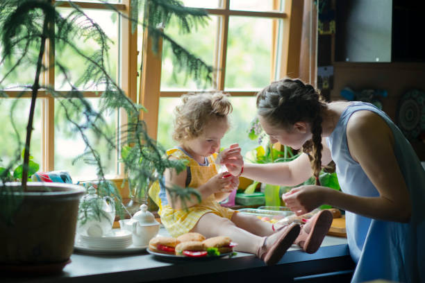 istock Mother and daughter on the kitchen 1156785809