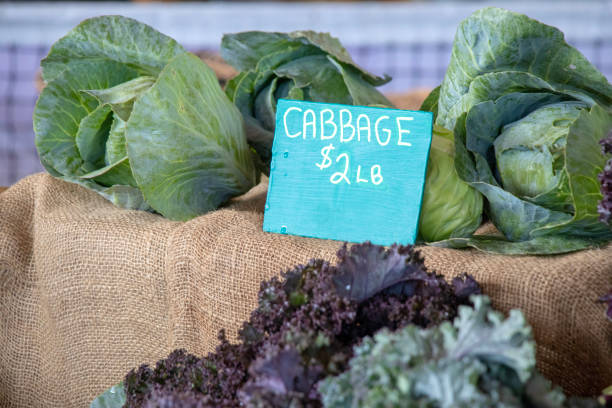 istock Closeup of cabbages for sale. 1156789627