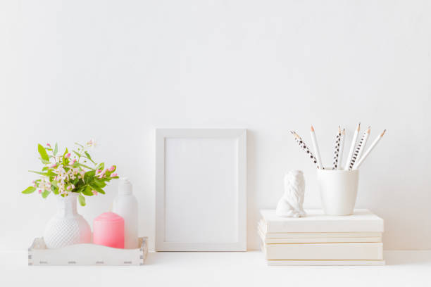 istock Home interior with decor elements. White frame, branches with green leaves in a vase, interior decoration 1156789727