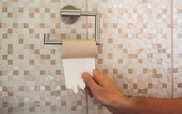istock hand with torn toilet paper 1156789806