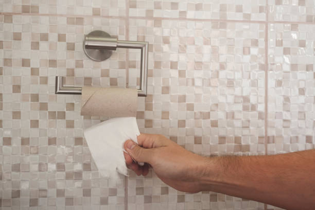 istock hand with torn toilet paper 1156789807