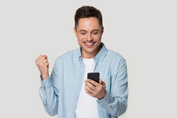 istock Happy Caucasian isolated excited get good message on mobile 1156795129