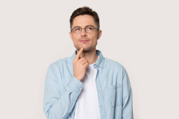 istock Thoughtful man in glasses isolated on grey background thinking 1156795136