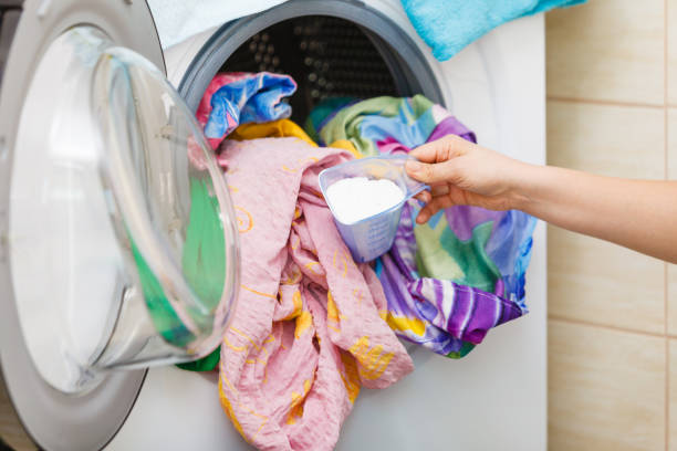 istock Woman wash laundry using powder detergent 1156796358