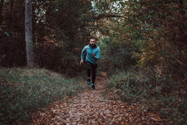 istock Man running and exercising in the nature 1156797795