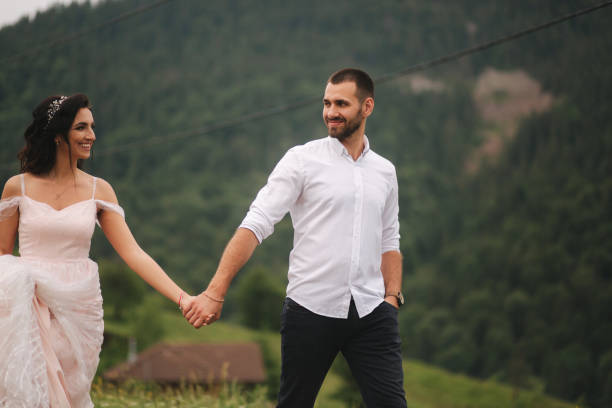 istock Groom and bride walking hougt the Carpathian mountains 1156797821
