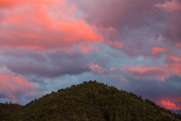 A mountain peak in the Sangre de Cristo Mountains near Santa Fe, New Mexico under beautiful clouds at sunset