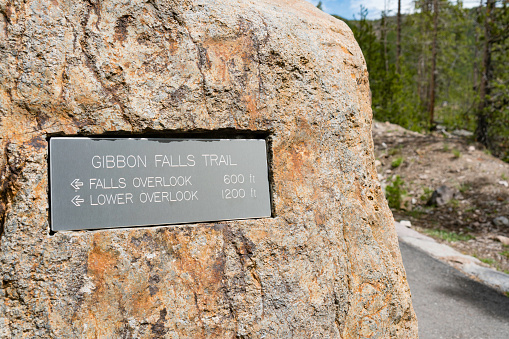 Sign directs to Gibbon Falls Trail in Yellowstone National Park.