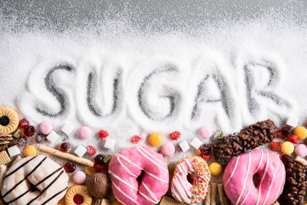 food containing sugar. mix of sweet donuts, cakes and candy with sugar spread and written text in unhealthy nutrition, chocolate abuse and addiction concept, body and dental care. - sugar imagens e fotografias de stock