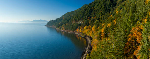 Samish Bay WA Chuckanut Drive Aerial Sunny Autumn Day Train Tracks Along Water Coast San Juan Islands Samish Bay WA Chuckanut Drive Aerial Sunny Autumn Day Train Tracks Along Water Coast San Juan Islands washington state coast stock pictures, royalty-free photos & images