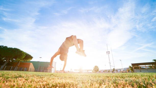 istock A young boy leaping somersault on the stadium 1156811561