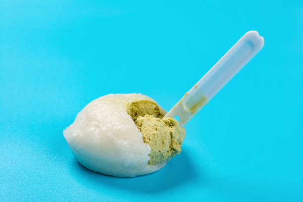 side view mochi dessert ice cream being eat on blue background