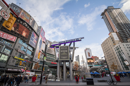 Toronto, Canada - August 22, 2023: Yonge-Dundas Square is a popular gathering point downtown with views of projected images. The Toronto Eaton Centre, a large shopping mall, stands across at 220 Yonge Street.