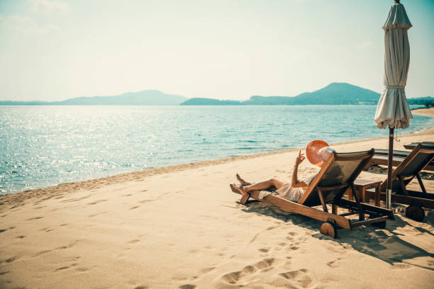 istock Woman in beach chair 1156822392