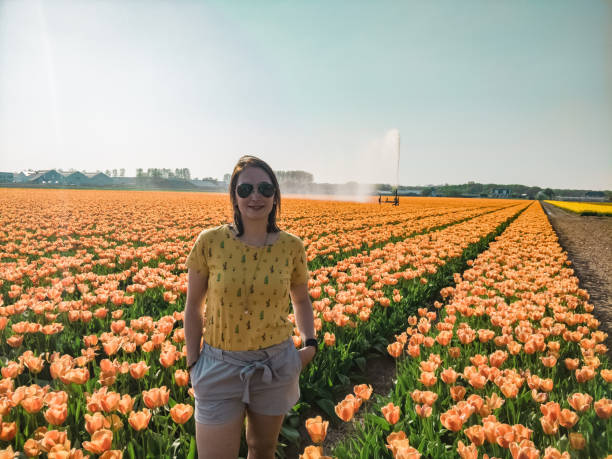 istock Woman between the orange flower fields in the Netherlands 1156822576
