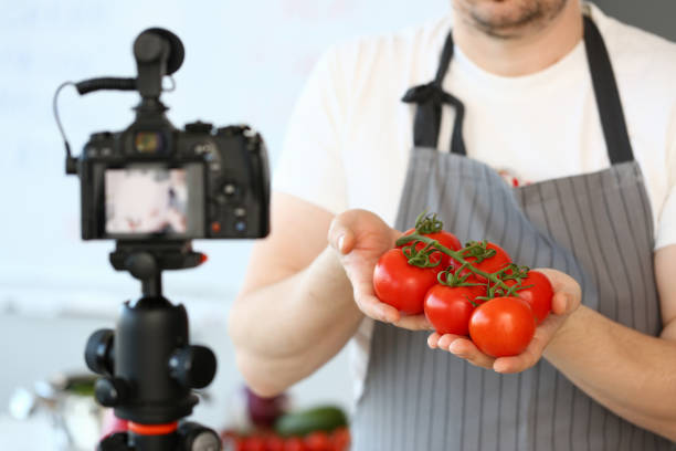 istock Vlogger Chef Showing Ripe Tomatoes Ingredient 1156822815