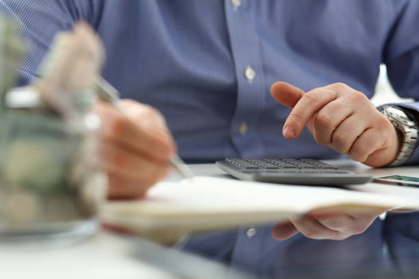 istock Male hand using calculator counting financial expenses 1156822881