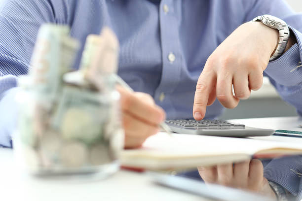 istock Male hand using calculator counting financial expenses 1156822882