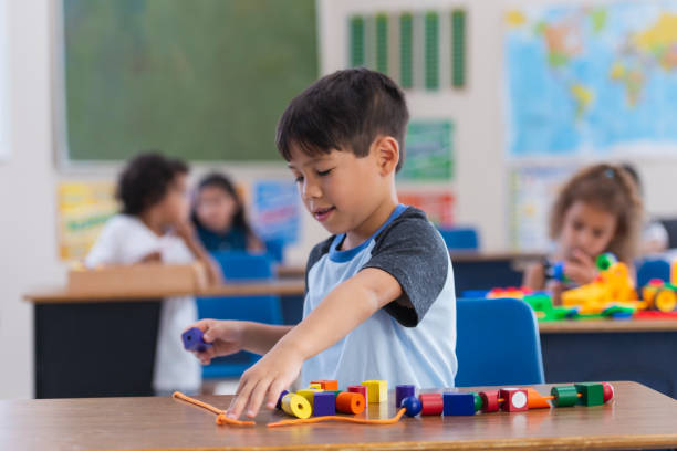 istock Adorable Little Kindergarten Boy Doing an In-Class Activity 1156823599