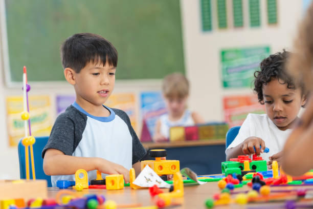 istock Adorable Little Kindergarten Boy Doing an In-Class Activity 1156823632