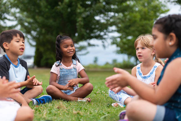 istock A Multi-Ethnic Group of Young Children are Clapping Outside 1156823647