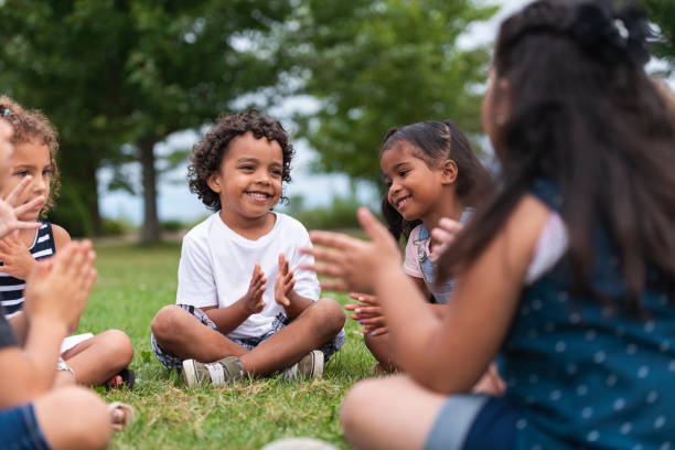 istock A Multi-Ethnic Group of Young Children are Clapping Outside 1156823654