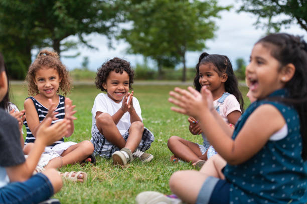 istock A Multi-Ethnic Group of Young Children are Clapping Outside 1156823659