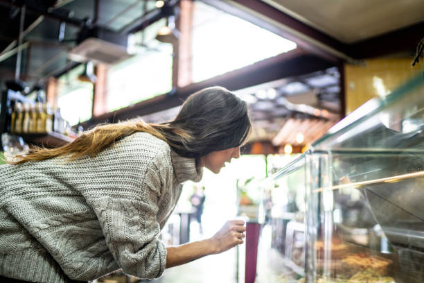 istock Woman choosing bread from a display in a bakery 1156827118