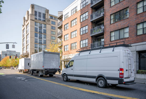 istock Convoy of different trucks with box trailers and long compact mini van 1156827878