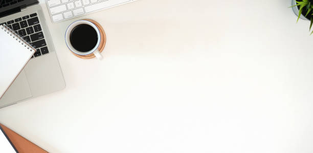 istock Stylish minimalistic workplace with keyboard, laptop, office supplies in flat lay style 1156830642
